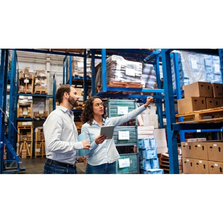 Two people with a tablet in a warehouse.